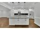 Granite kitchen island with white cabinets and pendant lighting at 10 Braemore Dr, Sandy Springs, GA 30328