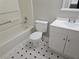 Clean bathroom with white vanity, bathtub, and black and white checkered floor at 2035 Marbut Trce, Lithonia, GA 30058