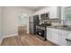 Updated kitchen with white cabinets, stainless steel appliances, and granite countertops at 1883 Cindy Dr, Decatur, GA 30032