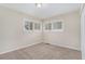 Well-lit bedroom with neutral walls, carpet flooring, and two windows at 1883 Cindy Dr, Decatur, GA 30032