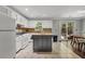 Bright kitchen with granite countertops, white cabinets, and kitchen island at 2320 Boone Pl, Snellville, GA 30078