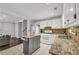 Modern kitchen featuring granite counters, white cabinets, and kitchen island at 2320 Boone Pl, Snellville, GA 30078