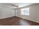 Bright living room with hardwood floors, large window, and ceiling fan at 6275 S Skyline Dr, Douglasville, GA 30135