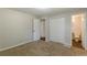 Well-lit bedroom featuring carpet, closet, and ensuite bathroom at 6275 S Skyline Dr, Douglasville, GA 30135