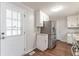 Kitchen area with white cabinets, granite countertops and door access at 6275 S Skyline Dr, Douglasville, GA 30135
