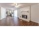 Open living room and kitchen with hardwood floors and fireplace at 6275 S Skyline Dr, Douglasville, GA 30135