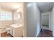 Clean bathroom with a vanity, toilet, and access to hallway at 6275 S Skyline Dr, Douglasville, GA 30135