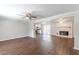 Open living room with dark wood floors and a brick fireplace at 6275 S Skyline Dr, Douglasville, GA 30135