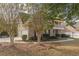 Side view of a two-story brick home with a three-car garage at 4348 Meadow Vista Dr, Stonecrest, GA 30038