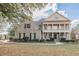 Two-story brick home with a front porch and landscaped yard at 4348 Meadow Vista Dr, Stonecrest, GA 30038