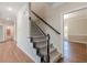 Elegant staircase with dark wood railing and carpeted steps at 4348 Meadow Vista Dr, Stonecrest, GA 30038