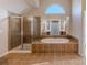 Bathroom featuring a large shower and a relaxing garden tub at 4348 Meadow Vista Dr, Stonecrest, GA 30038