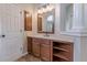 Bathroom with corner vanity and wood cabinets at 4348 Meadow Vista Dr, Stonecrest, GA 30038
