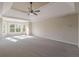 Bright main bedroom with tray ceiling, carpet, and ample natural light at 4348 Meadow Vista Dr, Stonecrest, GA 30038