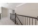 Upper hallway with carpet and iron railing at 4348 Meadow Vista Dr, Stonecrest, GA 30038