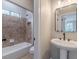 Modern bathroom with pedestal sink and shower/tub combo at 4348 Meadow Vista Dr, Stonecrest, GA 30038