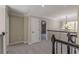 Upstairs hallway with neutral carpeting and elegant chandelier at 4348 Meadow Vista Dr, Stonecrest, GA 30038