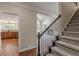 Elegant staircase with dark wood railing and carpeted steps at 4348 Meadow Vista Dr, Stonecrest, GA 30038