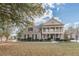 Two-story brick home with a front porch and landscaped yard at 4348 Meadow Vista Dr, Stonecrest, GA 30038