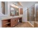 Bathroom vanity with wood cabinets and a large mirror at 4348 Meadow Vista Dr, Stonecrest, GA 30038
