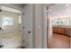 Hallway view of laundry room and kitchen with hardwood floors at 4348 Meadow Vista Dr, Stonecrest, GA 30038