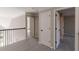 Upstairs hallway with neutral carpeting and doors to bedrooms at 4348 Meadow Vista Dr, Stonecrest, GA 30038