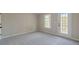 Bedroom with private balcony access and ceiling fan at 4348 Meadow Vista Dr, Stonecrest, GA 30038