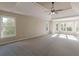 Spacious main bedroom with tray ceiling, large windows, and carpet at 4348 Meadow Vista Dr, Stonecrest, GA 30038