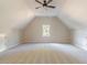 Spacious bonus room with neutral carpeting and ceiling fan at 4348 Meadow Vista Dr, Stonecrest, GA 30038