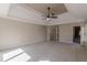 Main bedroom with tray ceiling, carpet, and access to bathroom and closet at 4348 Meadow Vista Dr, Stonecrest, GA 30038