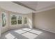 Main bedroom with bay window, tray ceiling, and carpet flooring at 4348 Meadow Vista Dr, Stonecrest, GA 30038