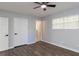 Spacious bedroom with hardwood floors, ceiling fan, and neutral walls at 7543 Palmetto Way, Riverdale, GA 30274