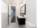 Clean bathroom with floating vanity, black matte faucet, and marble-like tile at 7543 Palmetto Way, Riverdale, GA 30274