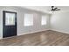 Bright living room with hardwood floors and ceiling fan at 7543 Palmetto Way, Riverdale, GA 30274