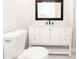 Clean bathroom with white toilet and vanity, and marble-look tile at 7543 Palmetto Way, Riverdale, GA 30274