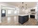 Modern kitchen with island, stainless steel appliances, and white cabinets at 7543 Palmetto Way, Riverdale, GA 30274