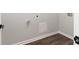 Bright laundry room with vinyl flooring and modern hookups at 7543 Palmetto Way, Riverdale, GA 30274