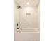 Clean bathroom with a bathtub and marble-look tile shower surround at 7543 Palmetto Way, Riverdale, GA 30274