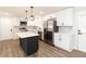 Updated kitchen featuring white cabinets and a large island at 7543 Palmetto Way, Riverdale, GA 30274