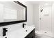 Modern bathroom with white subway tiles, double vanity, and black matte fixtures at 7543 Palmetto Way, Riverdale, GA 30274