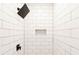 White subway tiled shower with black matte shower fixtures at 7543 Palmetto Way, Riverdale, GA 30274