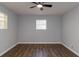 Bright bedroom with hardwood floors and neutral gray walls at 7543 Palmetto Way, Riverdale, GA 30274
