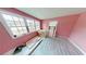 Pink bedroom with new flooring and windows under construction at 10591 Flat Shoals Rd, Covington, GA 30016