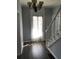 Bright entryway with hardwood floors, chandelier, and access to staircase at 3021 Stone Mountain St, Lithonia, GA 30058