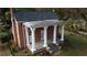 Brick home with a large front porch and columns, situated on a landscaped lawn at 3021 Stone Mountain St, Lithonia, GA 30058