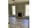 Living room with hardwood floors, fireplace, and large windows at 3021 Stone Mountain St, Lithonia, GA 30058
