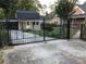Ornate black gate and fence leading to a house at 3021 Stone Mountain St, Lithonia, GA 30058