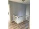 Upstairs hallway featuring hardwood floors and a white railing at 3021 Stone Mountain St, Lithonia, GA 30058