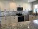 Modern kitchen with stainless steel appliances and granite countertops at 3021 Stone Mountain St, Lithonia, GA 30058