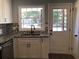 Kitchen features granite countertops, white cabinets, and a door to backyard at 3021 Stone Mountain St, Lithonia, GA 30058